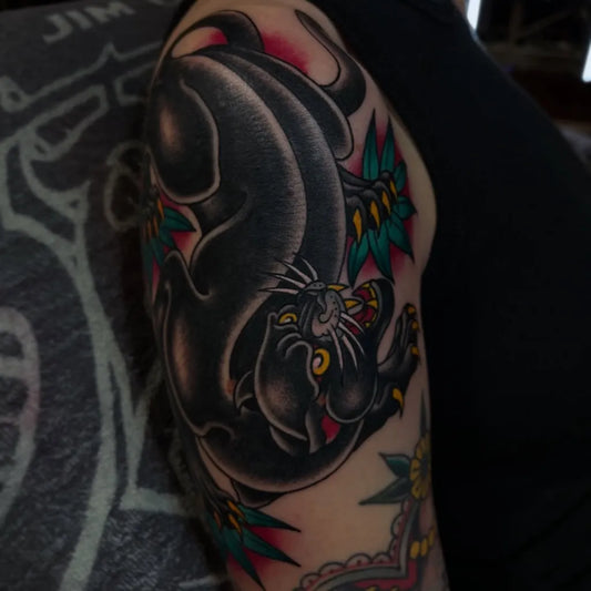 Big American Traditional Panther and Flowers Tattoo on Men Arm by @tadejatattoo