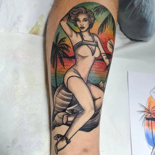 Big American Traditional Pin Up Girl with Palm Trees and Sunset Tattoo on Men Thigh by @adriannatattoo