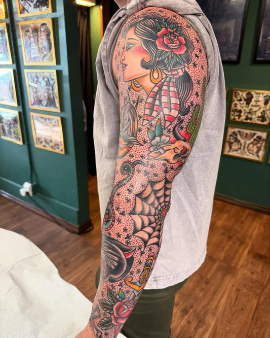 Big American Traditional Pinup Girl with Rose and Spiderweb on Men Arm Tattoo by @ryanmtattoos