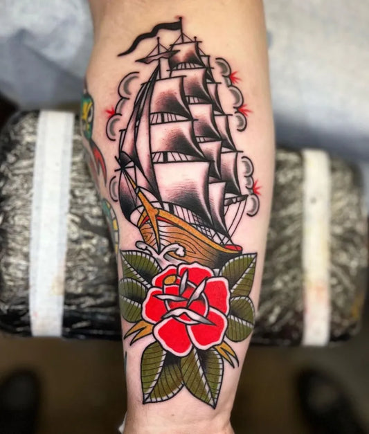 Big American Traditional Ship and Rose Nautical Tattoo on Men Arm by @sevenswordstattoocompany