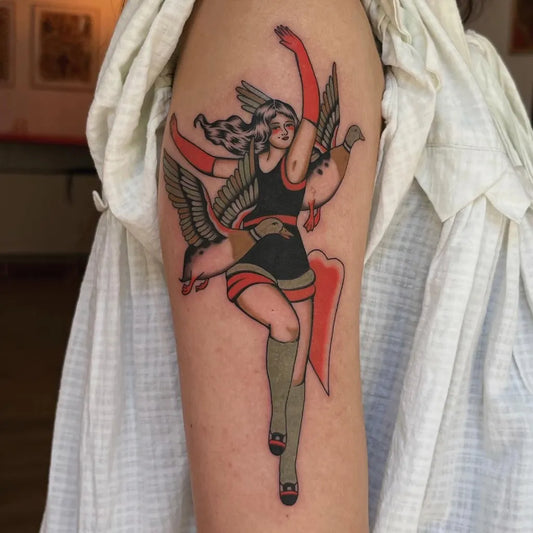 Big American Traditional Winged Woman with Duck on Women Arm Tattoo by @summers.tattoos