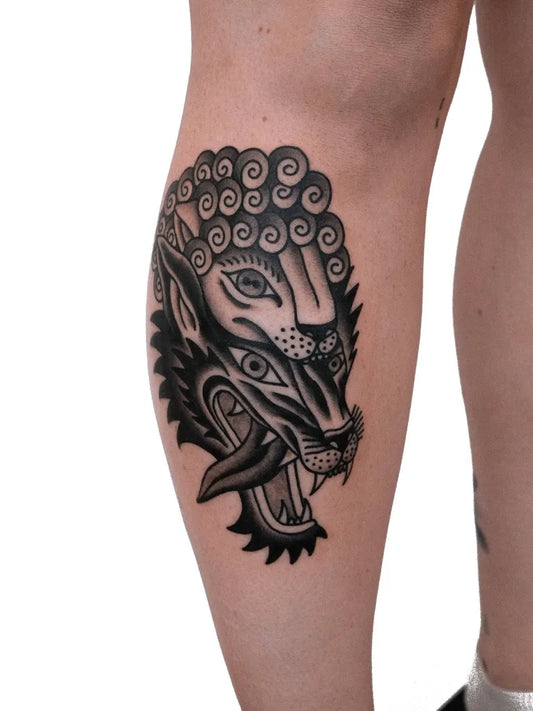 Big American Traditional Wolf Head on Women Leg Tattoo by @lejla_tattoo