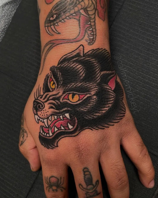 Big American Traditional Wolf and Snake on Men Hand Tattoo by @callmemickeyt