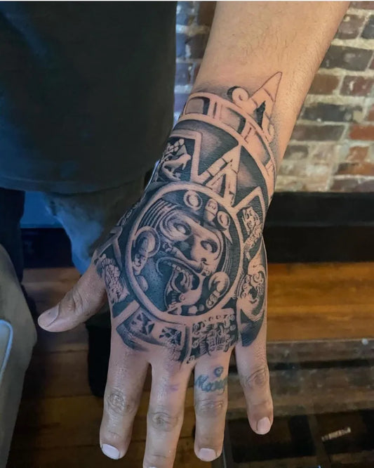 Big Aztec Sun Stone Tattoo on Men Hand by @mexicanstyle_tattoos