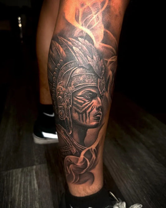 Big Aztec Warrior Face and Feathers Tattoo on Men Leg by @djorka_tatts