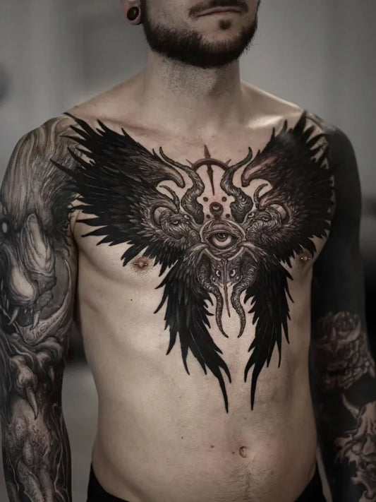 Big Black Wings with Eyes on Men Chest Tattoo by @chronicink