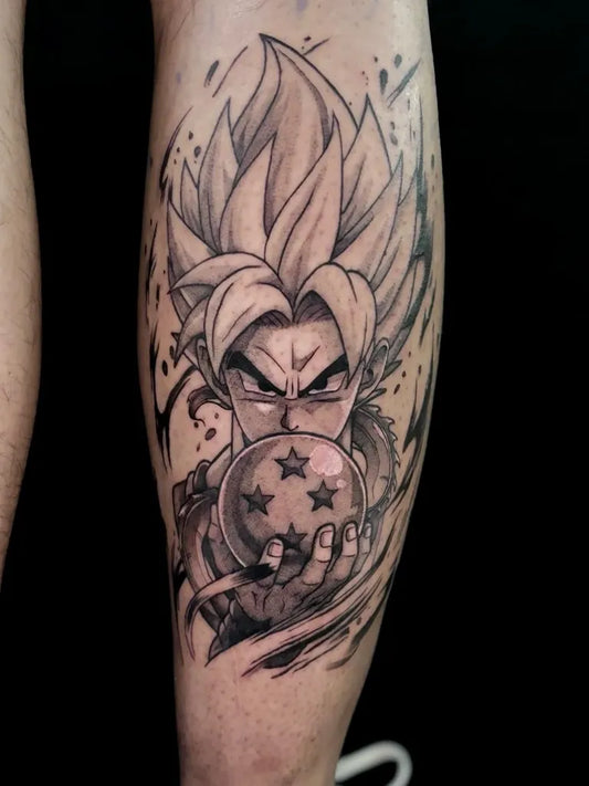 Big Black and Gray Goku Holding Dragon Ball on Men Arm Tattoo by @undertheneedle_london