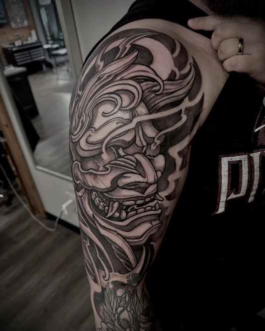 Big Black and Grey Abstract Oni Mask with Smoke and Flames on Men Arm Tattoo by @paulthompsontattoos