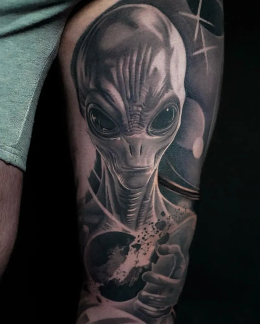 Big Black and Grey Alien with Planets Tattoo on Men Arm by @ellietaylor.tattoos