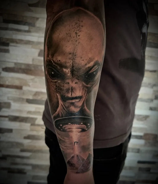 Big Black and Grey Alien with UFO and Pyramid Tattoo on Men Arm by @alessandrocomitotattoo