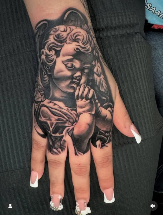 Big Black and Grey Angel Baby on Women Hand Tattoo by @mexicanstyle_tattoos