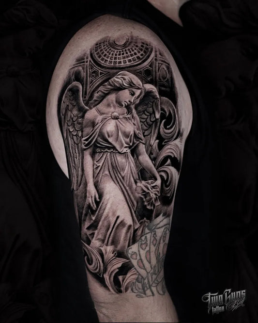 Big Black and Grey Angel Statue Tattoo on Men Upper Arm by @twogunstattoo_bali