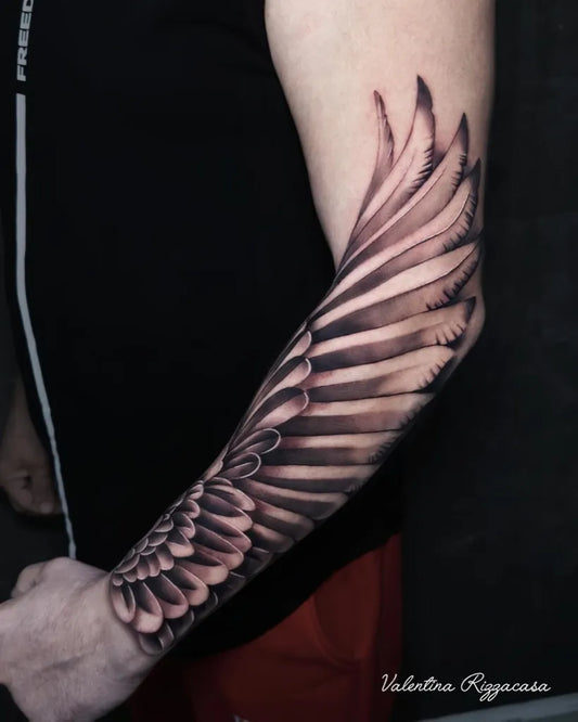 Big Black and Grey Angel Wings Tattoo on Men Arm by @valentina_rizzacasa