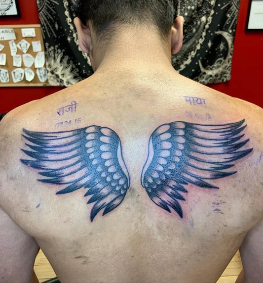 Big Black and Grey Angel Wings with Hindi Script Tattoo on Men Back by @cams__originals