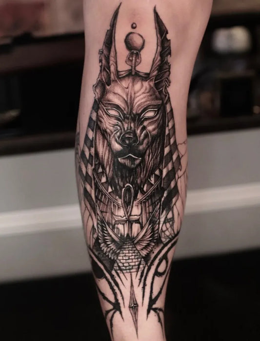 Big Black and Grey Anubis Head with Egyptian Motifs Tattoo on Men Leg by @tattooist_twoface
