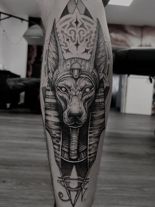 Big Black and Grey Anubis Tattoo on Men Leg by @katisaurus_tattoo