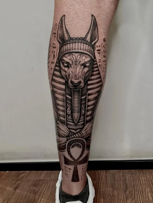 Big Black and Grey Anubis and Hieroglyphs Tattoo on Men Leg by @viniciusveronez.ink