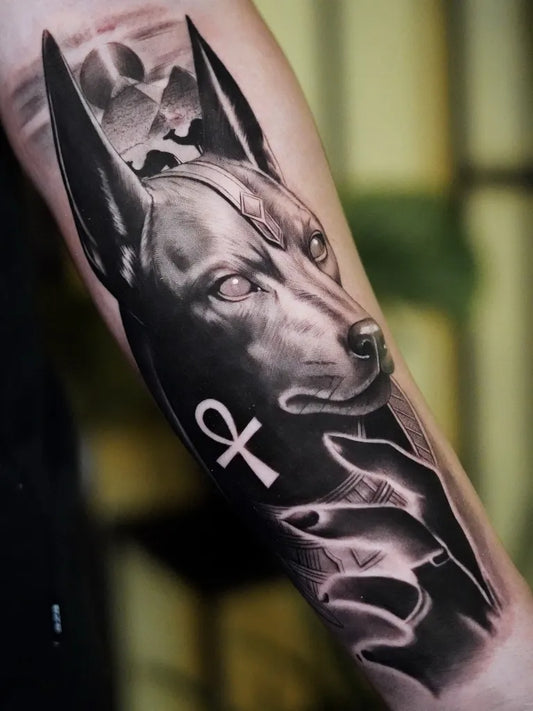 Big Black and Grey Anubis with Ankh Tattoo on Men Arm by @emtontattoo