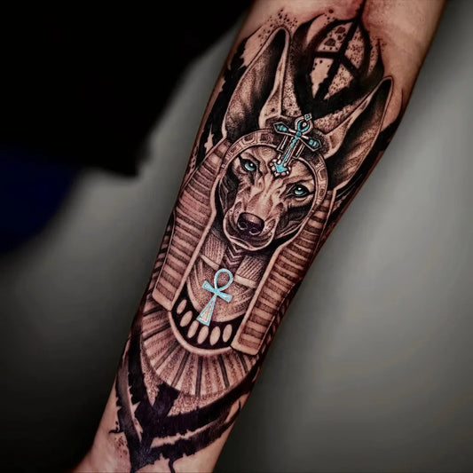 Big Black and Grey Anubis with Ankh Tattoo on Men Arm by @gatta_tattoo.mx