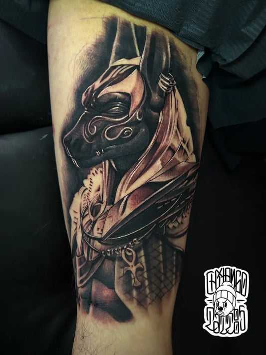 Big Black and Grey Anubis with Egyptian Armor Tattoo on Men Thigh by @chilango_tattoos