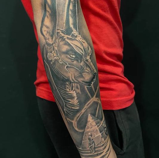 Big Black and Grey Anubis with Pyramid Tattoo on Men Arm by @jorditattoo