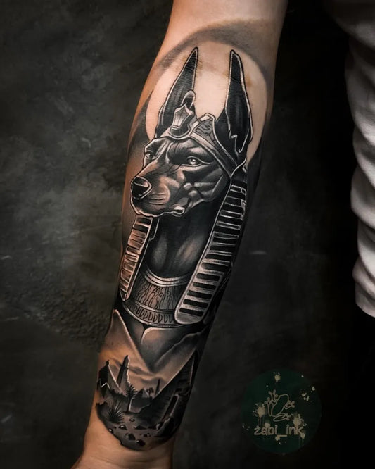 Big Black and Grey Anubis with Pyramids Tattoo on Men Arm by @zabi_ink