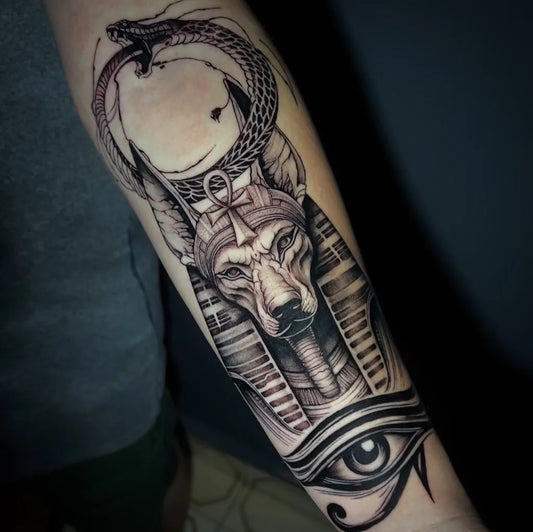 Big Black and Grey Anubis with Snake Tattoo on Men Arm by @negun_tattoo