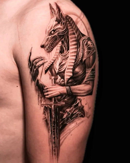 Big Black and Grey Anubis with Sword Tattoo on Men Shoulder by @leonarweiswork