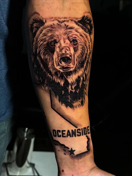 Big Black and Grey Bear Oceanside on Men Arm Tattoo by @bronco.tattoo