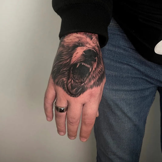 Big Black and Grey Bear on Men Hand Tattoo by @travel_and_tattoo