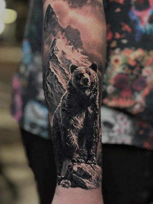 Big Black and Grey Bear on rocky mountain Men Arm Tattoo by @morozov_tattoo