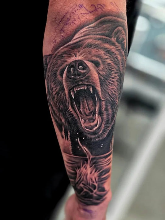 Big Black and Grey Bear with Campfire on Men Arm Tattoo by @katielooktattoos