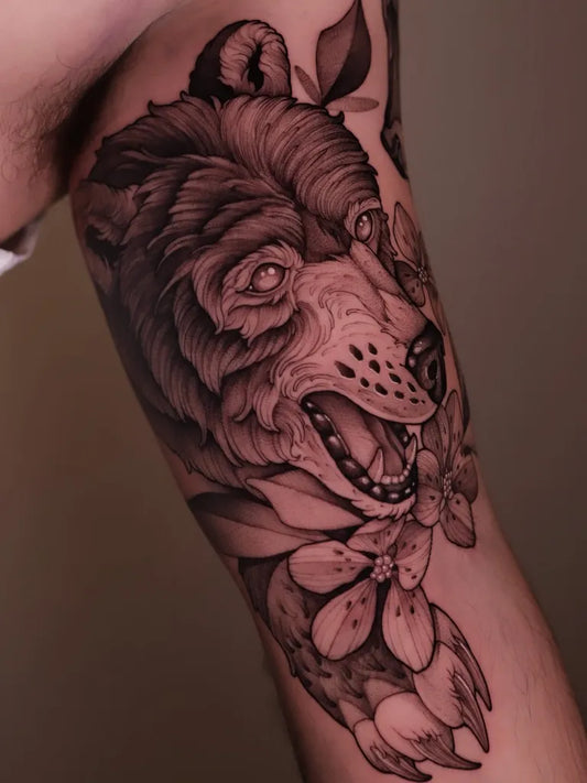 Big Black and Grey Bear with Flowers and Leaves on Men Arm Tattoo by @wolfang.ink