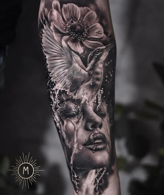 Big Black and Grey Bird and Flower and Face Tattoo on Women Arm by @andrea_ink_frencken