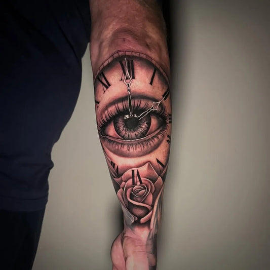 Big Black and Grey Clock Eye Rose Tattoo on Men Arm by @jackcoetattoo