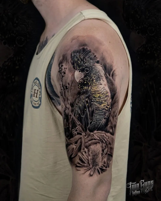 Big Black and Grey Cockatoo and Branches Tattoo on Men Upper Arm by @twogunstattoo_bali