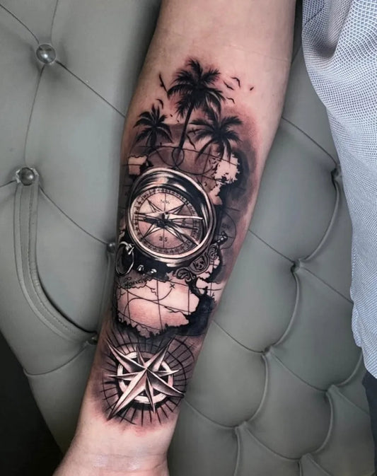 Big Black and Grey Compass with Palm Trees and World Map Nautical Tattoo on Men Arm by @salvationtattoostudio