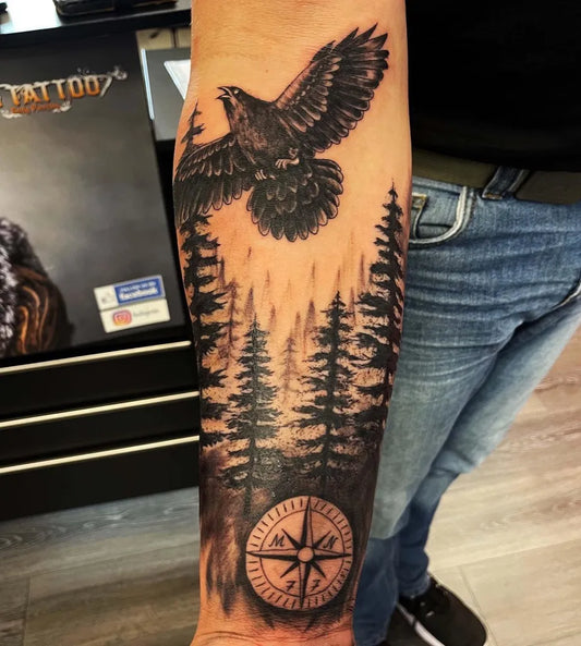 Big Black and Grey Crow Forest Compass Tattoo on Men Arm by @giotattookoblenz