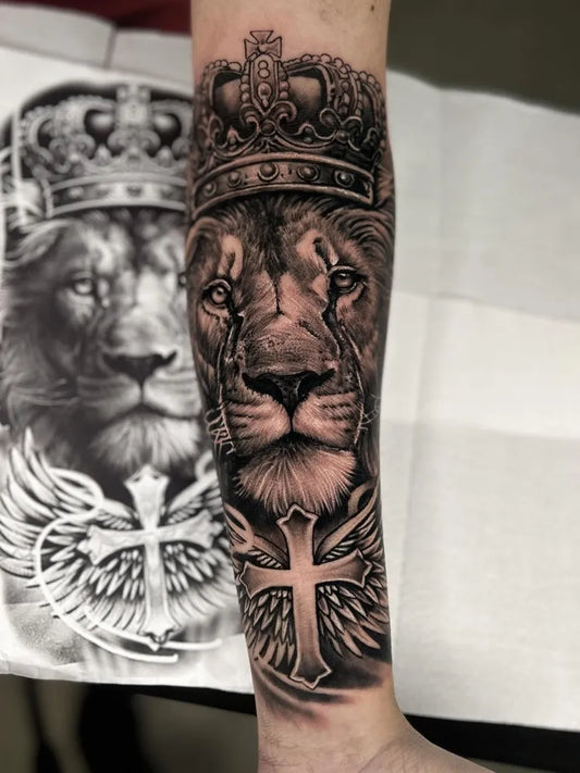 Big Black and Grey Crowned Lion with Wings and Cross Tattoo on Men Arm by @kauecamargo.tattoo