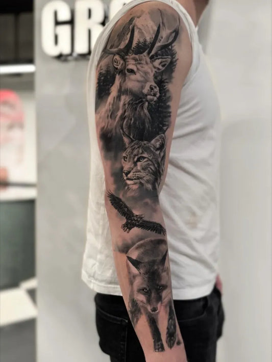 Big Black and Grey Deer Lynx and Raven Tattoo on Men Arm by @marianne.tattoo