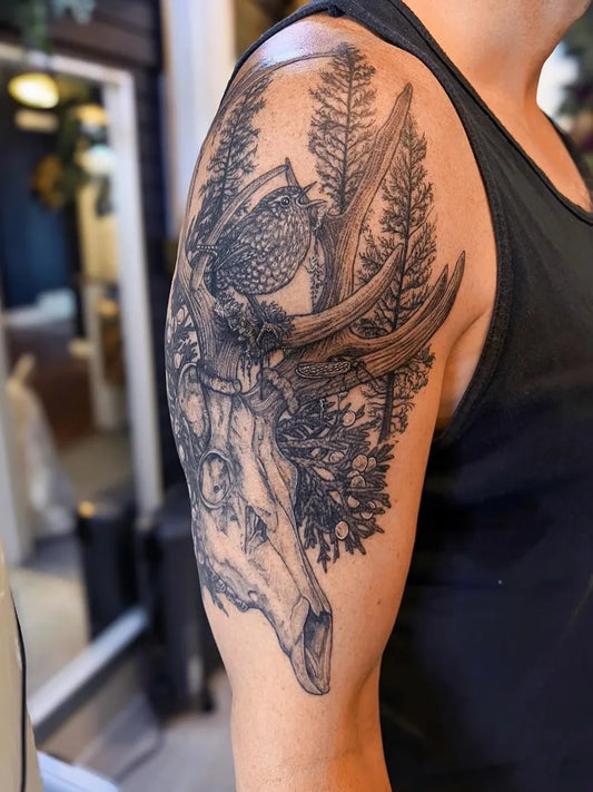 Big Black and Grey Deer Skull with Antlers and Trees Nature Tattoo on Men Shoulder by @thedimforest