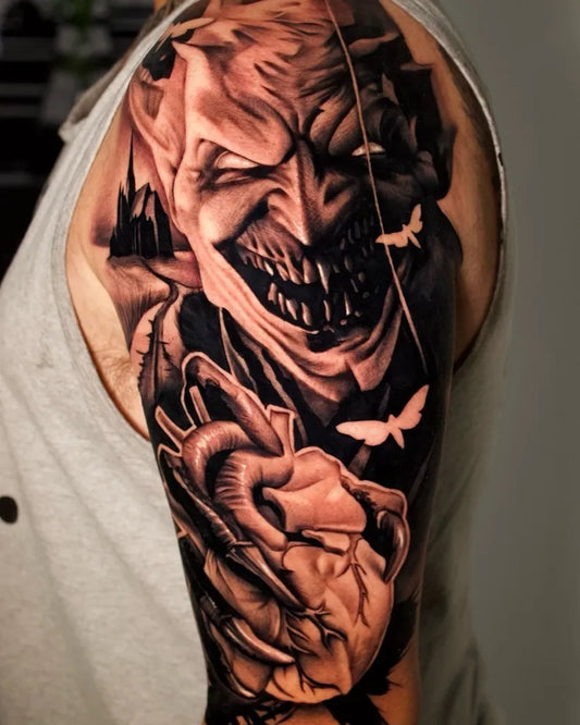Big Black and Grey Demon Joker with Heart Tattoo on Men Shoulder by @jeremy__doughty