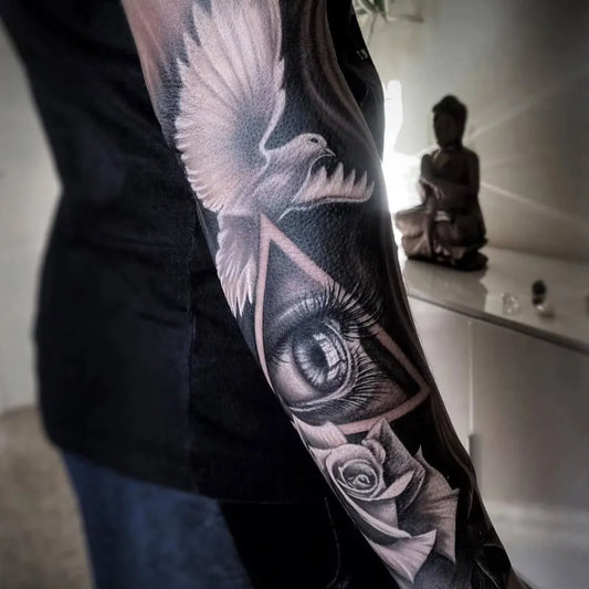 Big Black and Grey Dove Eye Rose Tattoo on Women Arm by @pinsnneedles_orihuela_costa