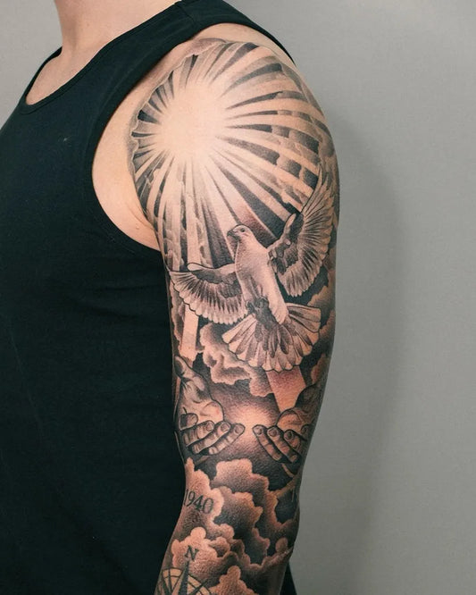 Big Black and Grey Dove and Sunburst Tattoo on Men Shoulder by @nicolasvalsantattoo