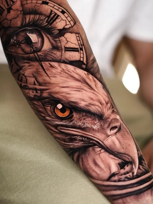 Big Black and Grey Eagle Clock Eye Tattoo on Men Arm by @melta.ttoo