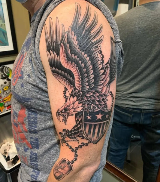 Big Black and Grey Eagle Shield Dog Tags Military Tattoo on Men Arm by @kingsavetattoo
