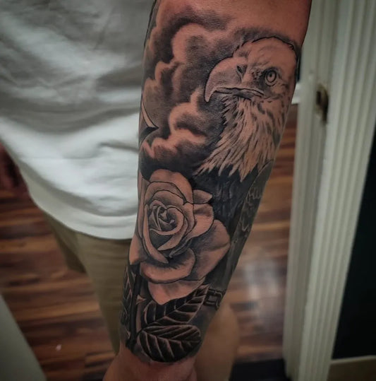 Big Black and Grey Eagle and Rose Tattoo on Men Arm by @davincitattoostudio