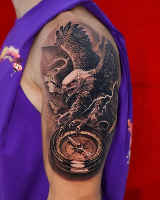 Big Black and Grey Eagle with Compass Tattoo on Men Shoulder by @dragoncityink.danang