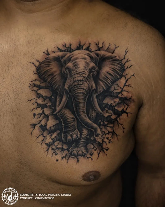 Big Black and Grey Elephant Breaking Through Wall Tattoo on Men Chest by @bodyarts_blr