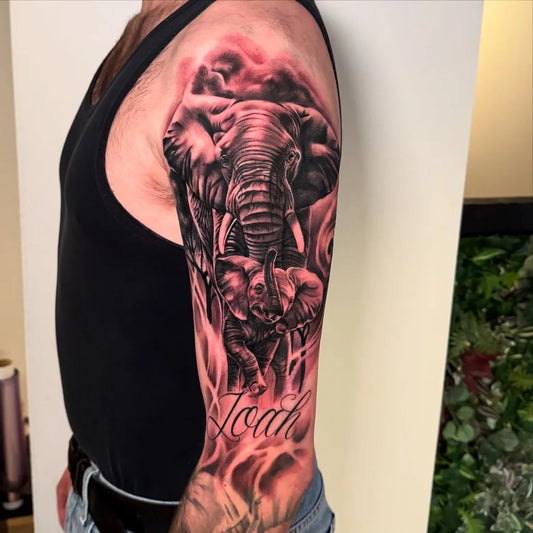 Big Black and Grey Elephant and Baby Tattoo on Men Arm by @juulstattoos